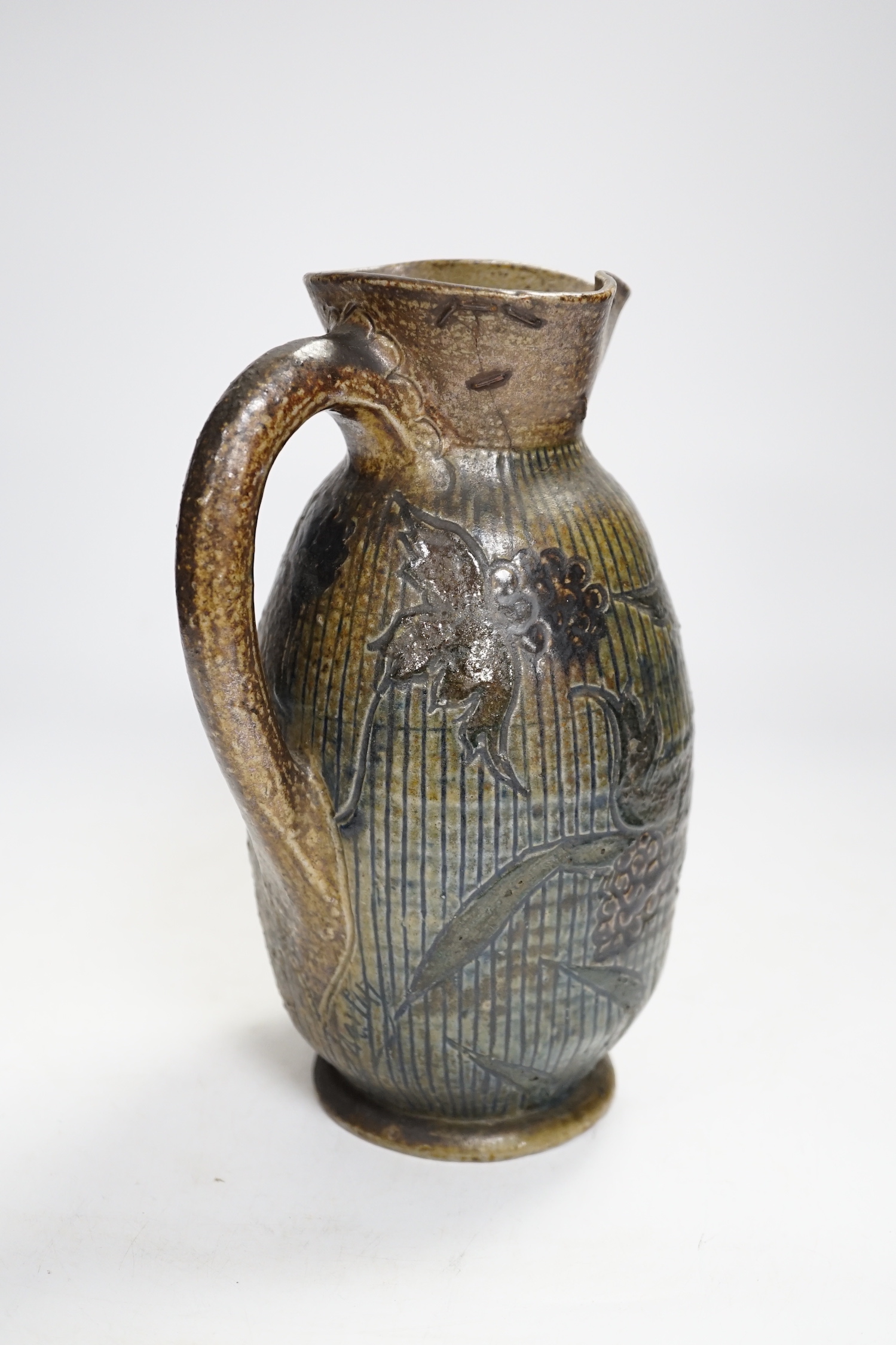 A R W Martin Brothers, London and Southall stoneware jug, repaired, mark to base, 22cm high